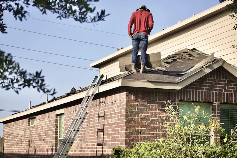 Professional roofer working on a residential roof in Bonhamtown